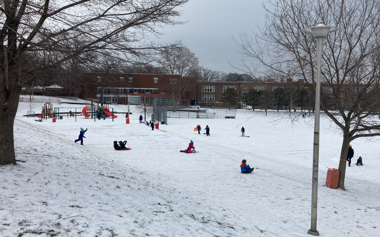 Children tobogganing at the Fairmount Park Toboggan Hill