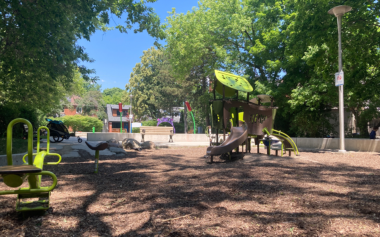Playground at Pottery Playground Park with the splash pad in the background.