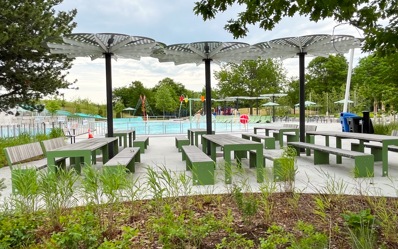 Turtle clan picnic area with long tables and benches beneath shade structures at Kidstown Waterpark