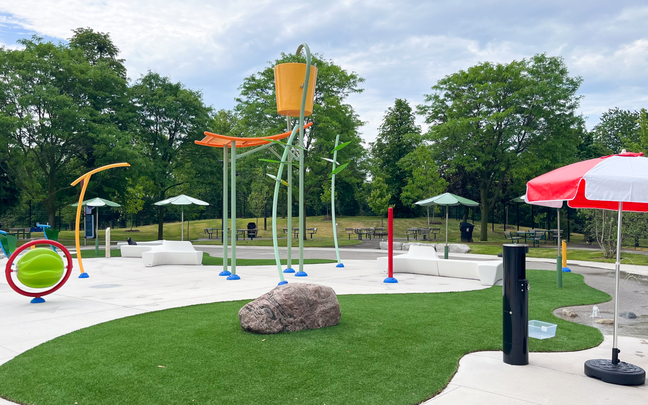 Splash pad area with a tipping bucket and many water jets at Kidstown Waterpark