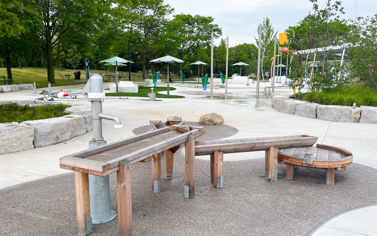 Wooden waterplay table with a hand pump at Kidstown Waterpark