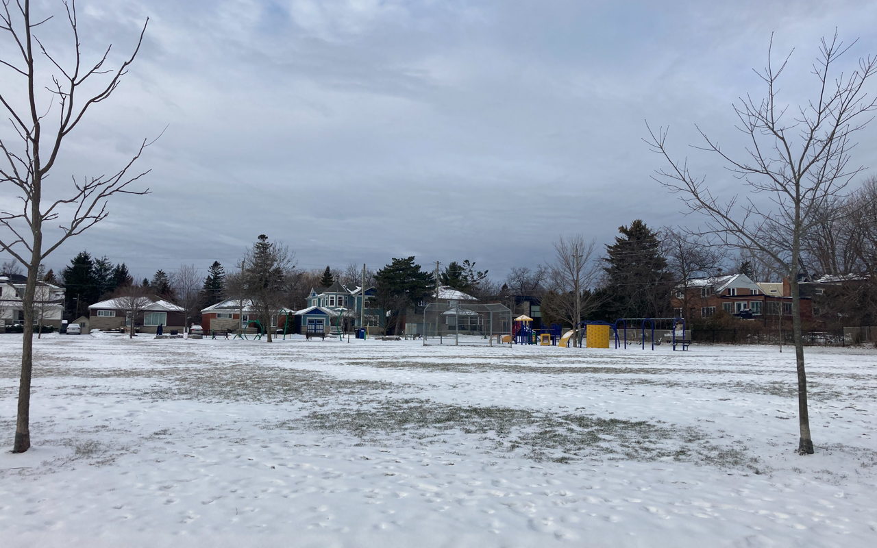 Sports field where the Natural Ice Rink is formed. The playground and splash can be seen in the background