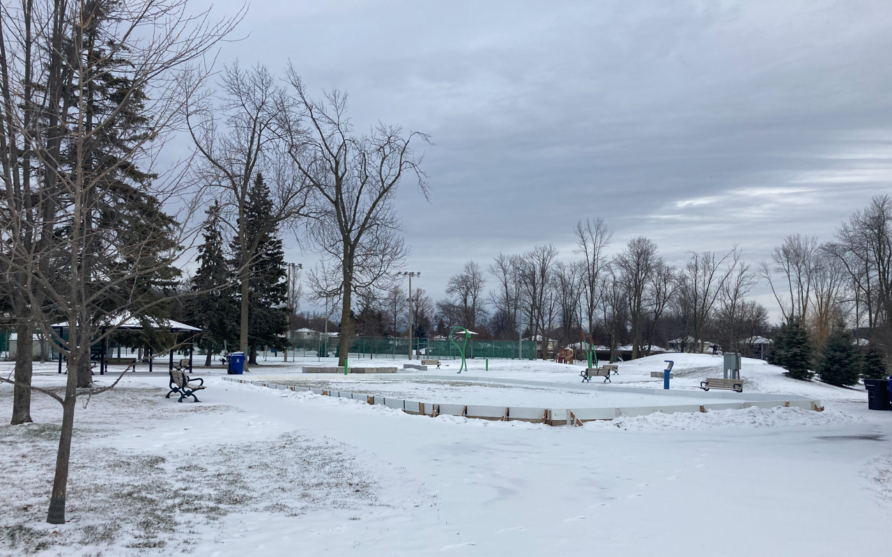 The Natural Ice Rink at Elizabeth Simcoe Park. The tennis courts, children's playground and splashpad can be seen in the background.