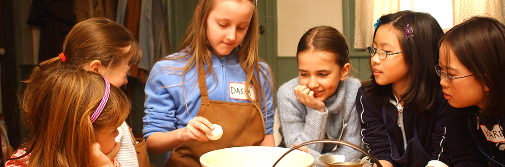 Children cooking at a camp.