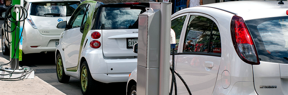 Smart cars waiting in line to receive electrical charge