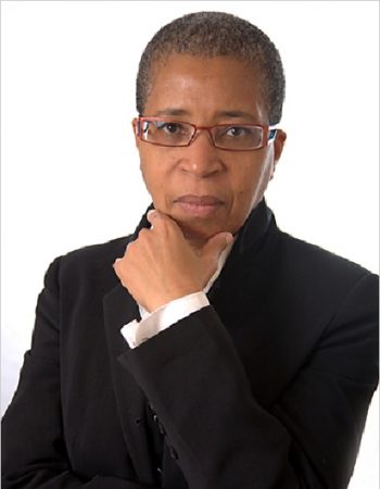 Headshot of Dionne brand holding her hand beneath her chin