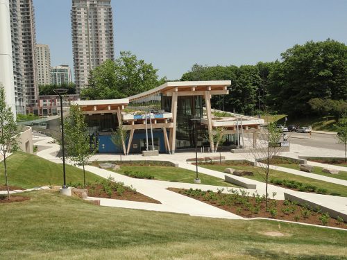 a photograph of Scarborough Centre Public Library showing the surrounding green landscape, condominiums and road