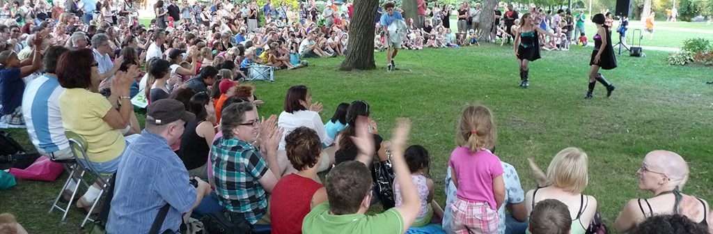 Large crowd cheers outdoor Dusk Dances