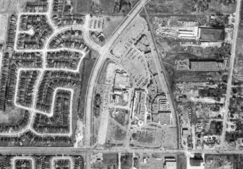 Aerial view of houses and shopping mall.
