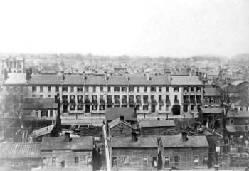 A line of row houses from left to right, with columned Osgoode Hall in upper left