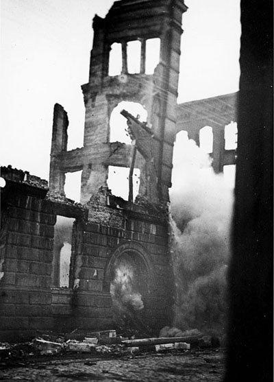 The remaining four-storey wall section is demolished by dynamite.