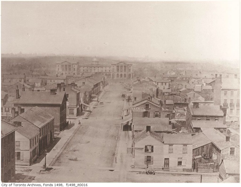 Looking over two-storey houses to grand Osgoode Hall