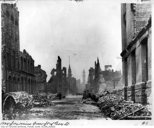 The facades of some of the buildings are still standing, but many are half-fallen or gone. Bay Street is filled with rubble.