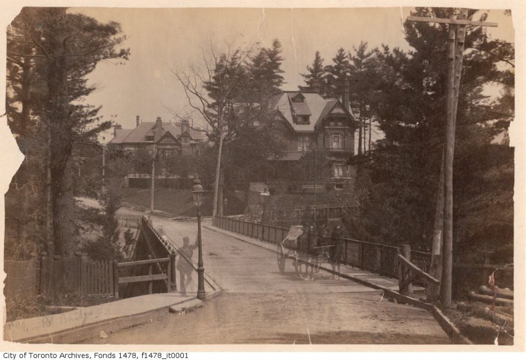 Bridge with large houses beyond.