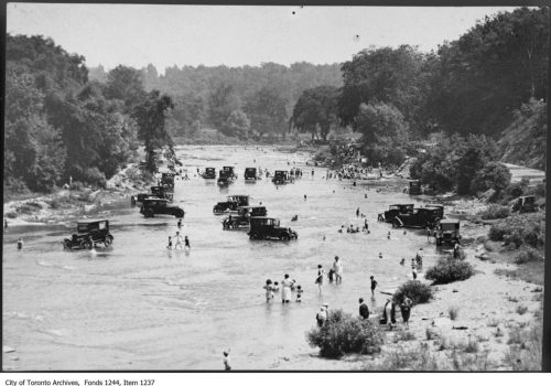 Bathers and cars in Humber River