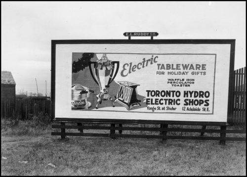 Billboard ad showing electric coffee maker, waffle iron and toaster.