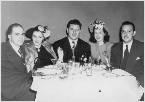 Five people sitting around a circular table.