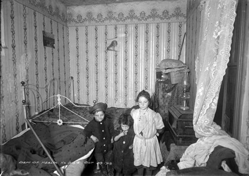 Children in a crowded, cluttered room