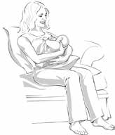woman sitting on a sofa breastfeeding her baby