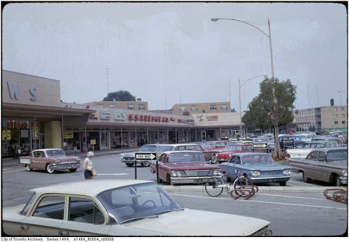 Looking over a parking lot to a Kresge's store.