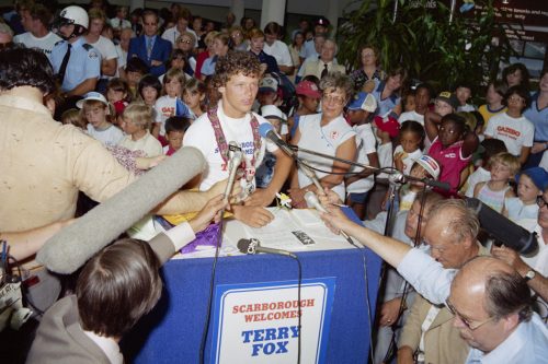 A picture of Terry Fox speaking to a huge crowd inside Scarborough Civic Centre