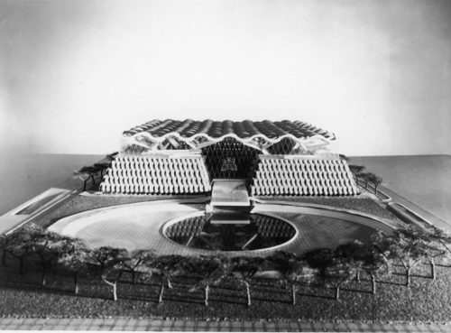 Model of short building with two quadrilateral sections joined by a wave-shaped roof