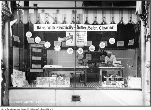 Shop window displaying stoves with the slogan "Bake with electricity, better, safer, cleaner."