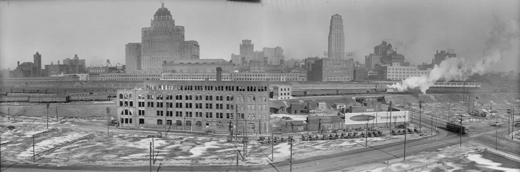 An abandoned industrial site, trains, and then the tall city buildings in the background.