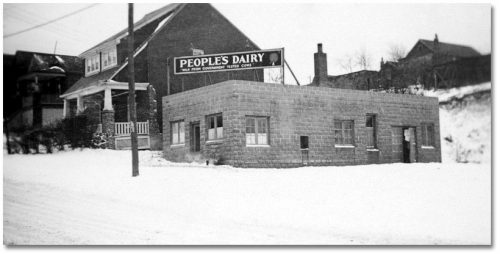 Small, rectangular concrete stone building with People's Diary sign on roof.