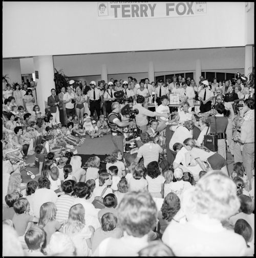 A picture of Terry Fox inside Scarborough Civic Centre surrounded by a huge crowd