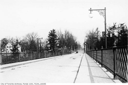 Bridge with decorative metal railings and lamppost.