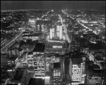 New City Hall and downtown with the office buildings all bright with lights, and the roads showing as long lines of light.