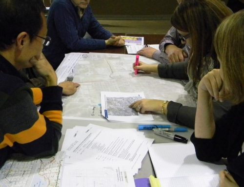 Attendees of the March 2017 Keele Finch Plus public workshop pointing at a map.