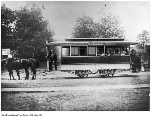 Small streetcar pulled by two horses.