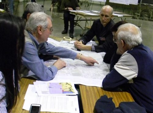 Attendees of the March 2017 Keele Finch Plus public workshop pointing at a map.