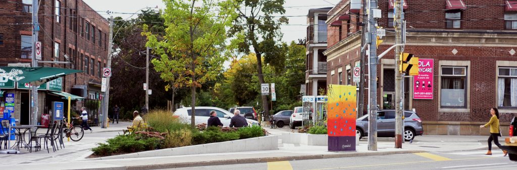 intersection with garden, seating and mural