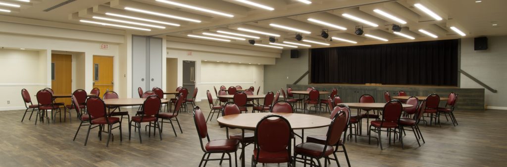 Memorial Hall Burgundy Room with a round tables setup throughout the room