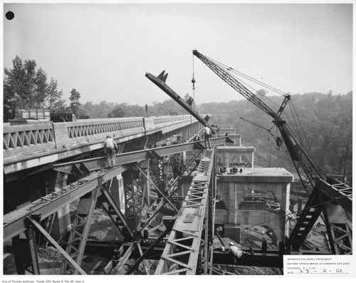 Workmen placing steel trusses