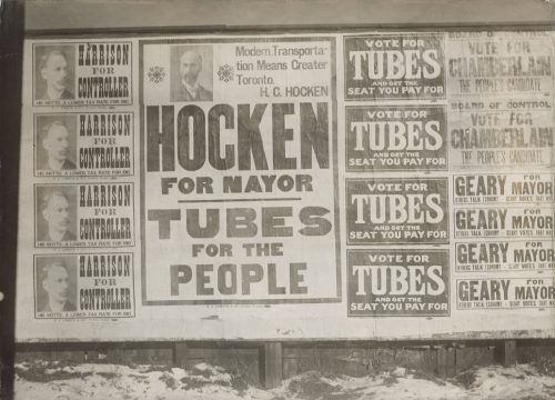 Posters saying "Hocken for mayor, tubes for the peopl" and "Vote for tubes and get the seat you pay for.".