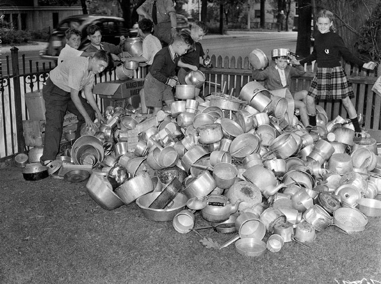 Children with a large heap of pots and pans.