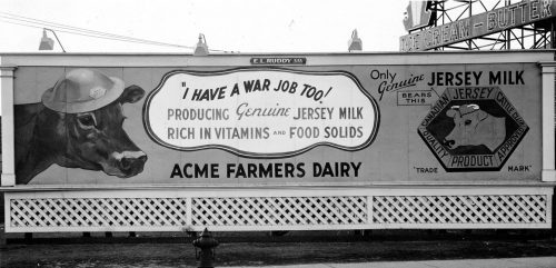 Billboard showing cow in army helmet.