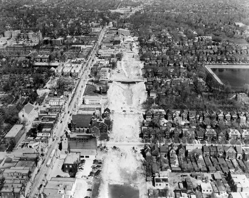 Aerial photo showing trench dug for subway, Yonge Street business area on one side, houses on the other