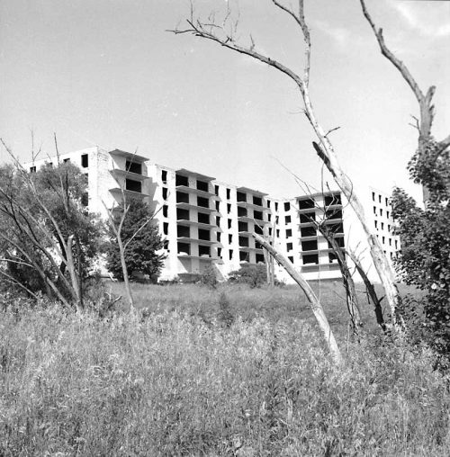 White highrise building with no windowpanes installed