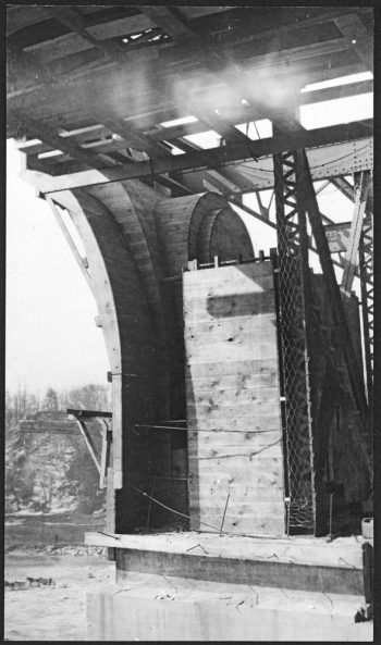 Concrete and wooden form underneath bridge deck.