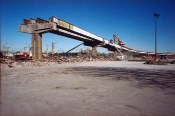 A few concrete support pillars and steel beams remain, ending as though cut off straight