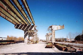 Rusty beams resting on concrete pillars with horizontal supports cut in half