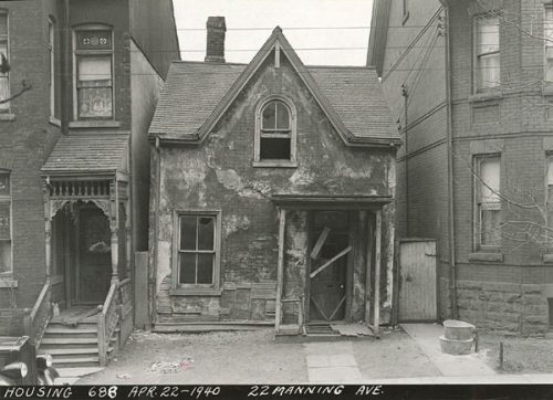 Old broken-down house with broken door, falling plaster