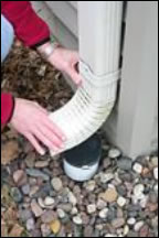 Inserting the downspout elbow to the bottom of the downspout.