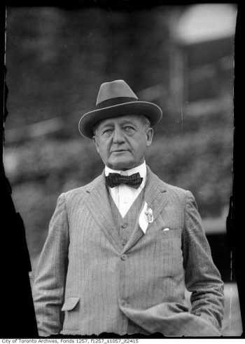 Man in striped suit, bow tie, and hat.