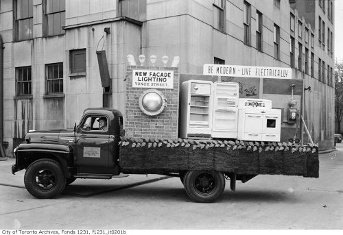 Truck bed with electric lights and stoves and refrigerators on the back.